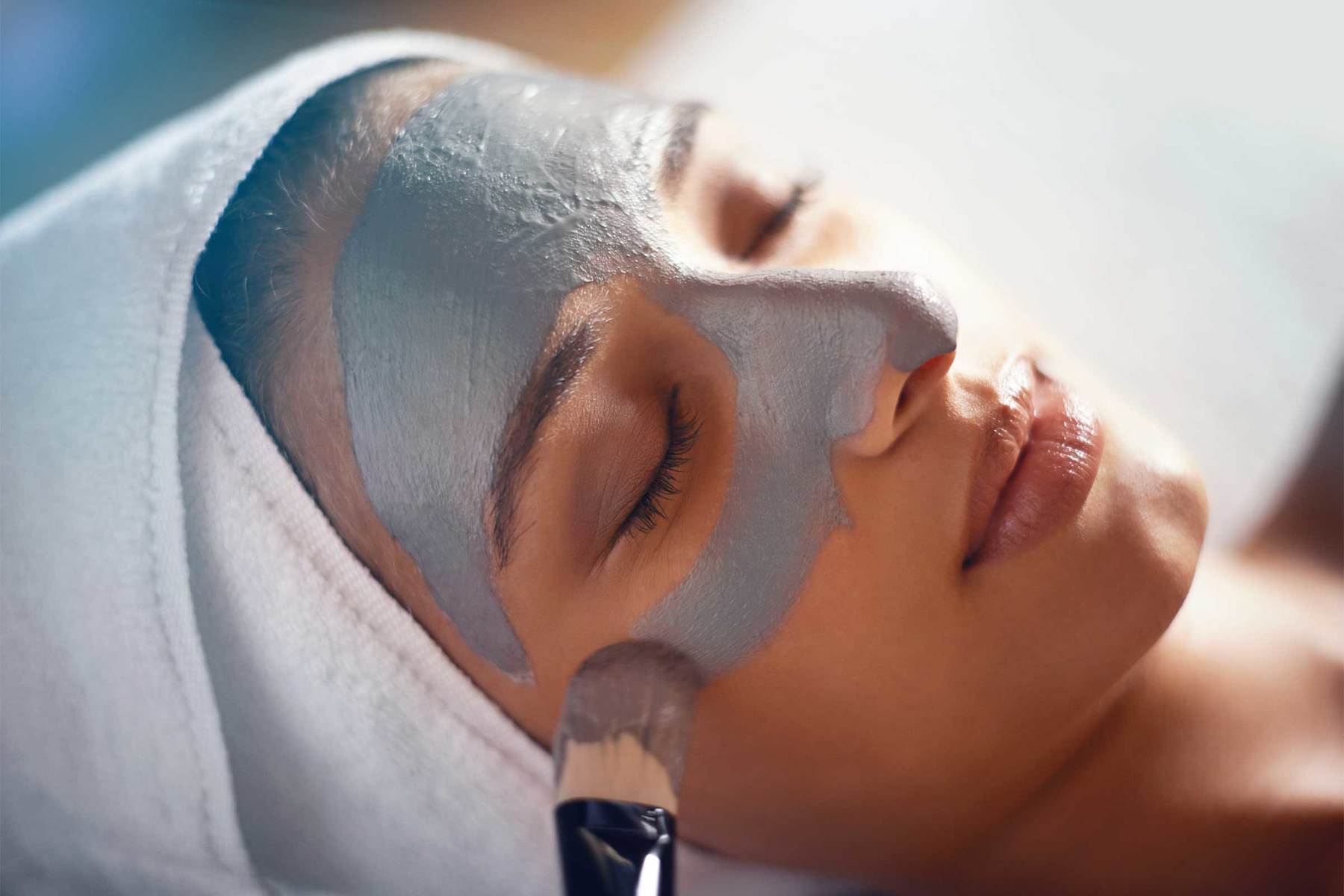 A woman in Dallas recieving a luxurious facial treatment